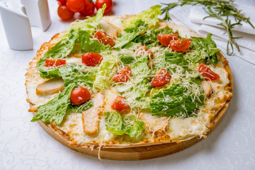 Pizza Caesar with chicken and tomatoes on board