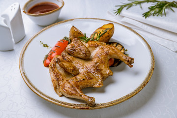 fried chicken tobacco with fried vegetables on white plate