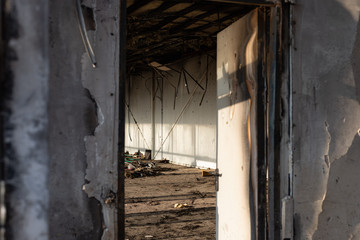 view through an open door to a burnt room after a fire. horizontal image. selective focus.
