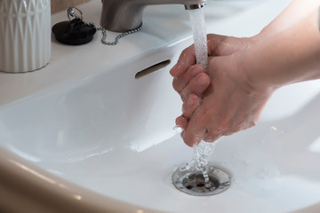 Hand washing under running water, for good cleaning and hygiene.