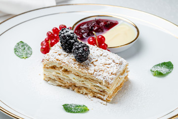 Napoleon dessert on plate with fresh berries