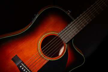 Fototapeta na wymiar Guitar. Acoustic six-string guitar case close-up on a black background.