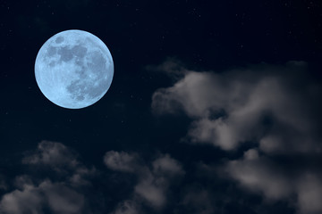 Fototapeta na wymiar Full moon on the sky and soft blurred clouds.