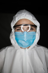 Close up portrait image of a health worker wearing protective clothing and masks working with Vaccines for dangerous viruses