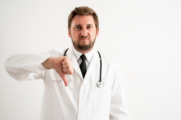 Male doctor with stethoscope in medical uniform showing showing dislike