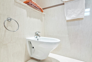 Modern bathroom with white ceramic bidets. Close-up.