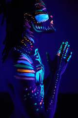 side view on calm african prayer with ethnic fluorescent prints on skin, male meditate to be kind...