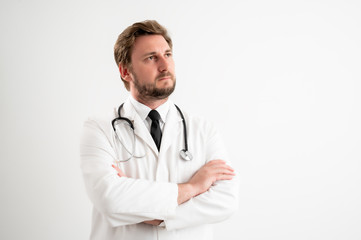 Male doctor with stethoscope in medical uniform looking confident hero-shot