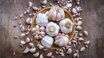 Top view close up, Garlic bulbs in wooden basket for cooking background , copy space for your text