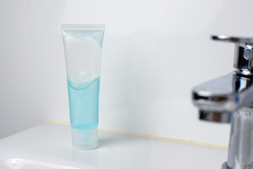 Alcohol sanitizer bottle on wash basin in toilet for disinfecting surface in a home,Coronavirus and Covid-19 prevention concept.