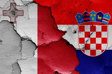 flags of Malta and Croatia painted on cracked wall
