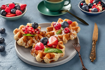 Belgian Waffles with fresh fruit and mint leaves, tasty breakfast