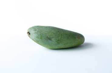 The picture of ripe and raw mangoes on a white scene