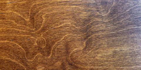 dark lacquered veined wood surface top view, brown background texture