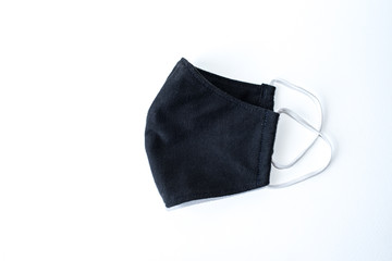 A black cloth mask in a white scene