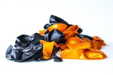 Black and orange balloons on a white scene