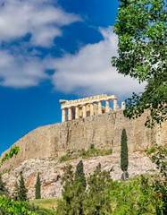 Fototapeta na wymiar Athens Greece, parthenon temple on acropolis hilll and vibrant greeen foliage