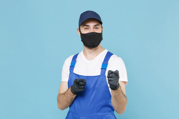 Delivery man in cap t-shirt coveralls uniform sterile face mask gloves isolated on blue background...