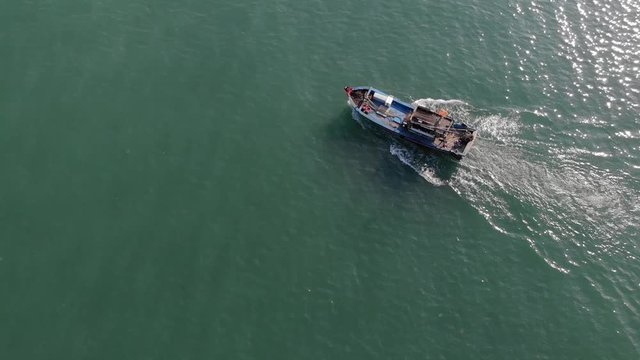 Flying over a boat sailing into the sea. Vietnam