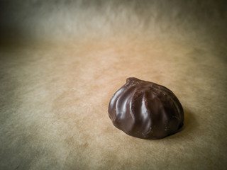 White marshmallows in chocolate on parchment paper