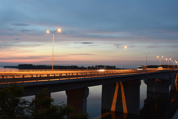 Along the long bridge over the Danube is a series of public high street lamps with orange light