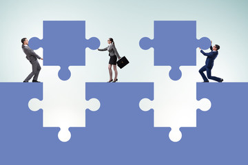 Businessman in teamwork concept with jigsaw puzzle