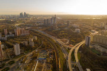 Fototapeta na wymiar panoramic view with skyscrapers and highways of a big city filmed from a drone
