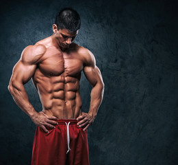 Fototapeta na wymiar Muscular Men Posing and Flexing Muscles