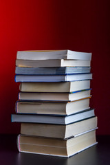 stack of books on red background closeup