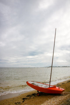 Sailboat Moored On Beach Against Sky
