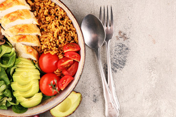 Healthy salad bowl with quinoa, tomatoes, chicken, avocado and mixed greens, lettuce. Food and health bowl