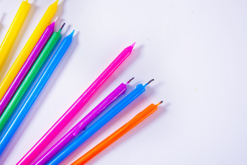 Thin colorful candles. Copy space. Top view.