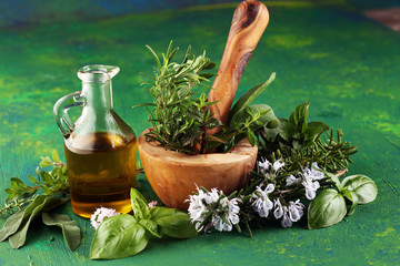 Homegrown and aromatic herbs on rustic background with rosemary and basil