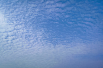 Blue summer sky with white cumulus clouds. Blue sky with clouds nature background.