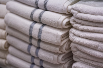 Pile of new towels in shop on a regiment, shallow depth of field, texture background.