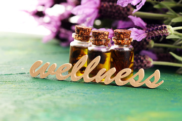 lavender herbal oil and lavender flowers. bottle of lavender massage oil for aromatherapy treatment...