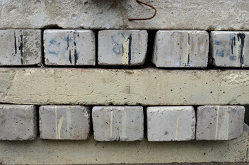 Gray urban background - concrete blockes stacked for building a road, road borders