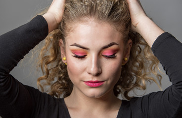 Beautiful young girl with colourful makeup. Make up, crazy hairstyle, lipstick, eye shadows, hair. 