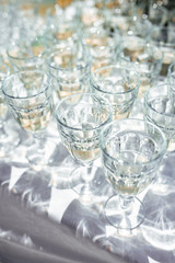 Crystal glasses with drinks on a sunny day. Hard shadows and highlights. Top view