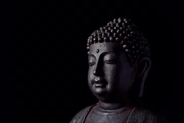 Gartenposter Meditating Buddha Statue isolated on black background. Copy space.  © Eugeniusz Dudziński