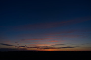 The night sky with clouds and stars