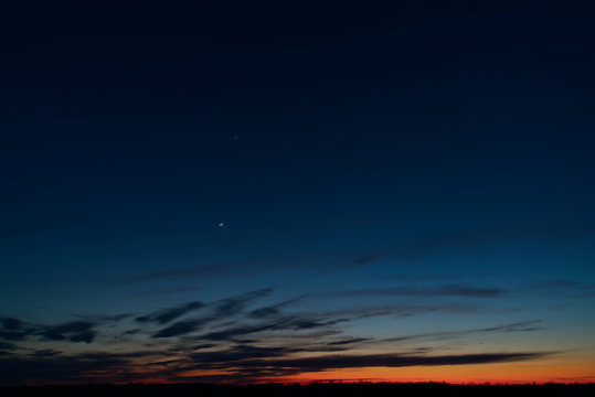 The night sky with clouds and stars