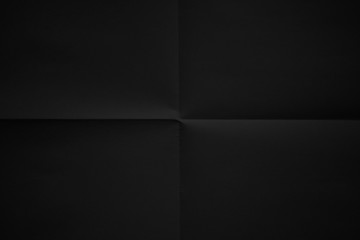 Black paper folded in four fraction background
