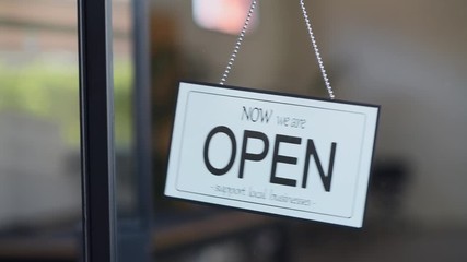 Reopening of a small business activity after the covid-19 emergency, ended the lockdown and quarantine. A business sign that says now we are open support local businesses on cafe or restaurant.