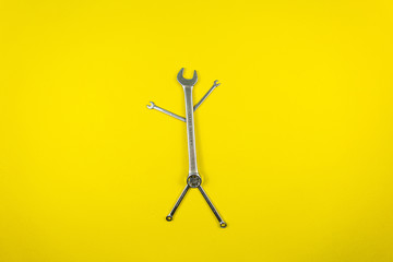 Set of wrenches of different sizes on a yellow background