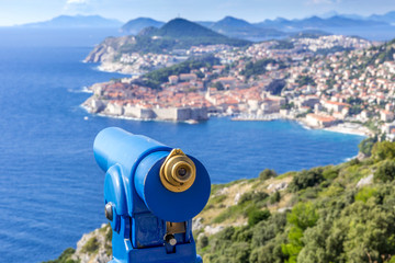 Focus on telescope looking over defocused background of croatia