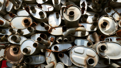 close up of a pile of steel pipes and mufflers background texture or wallpaper