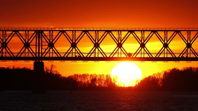 Railway bridge over the river at the stunning dawn