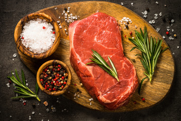 Fresh beef steak on black table.