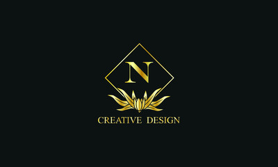 Fototapeta premium Elegant design of royal vector logo with letter N on black background. Stylish golden floral monogram for business, restaurant, boutique, cafe, hotel, labels and more.